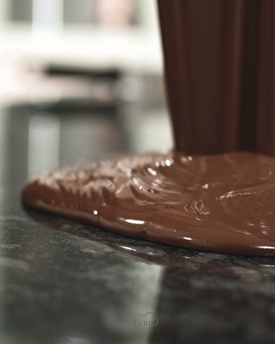 Couverture chocolate being worked by hand on stone